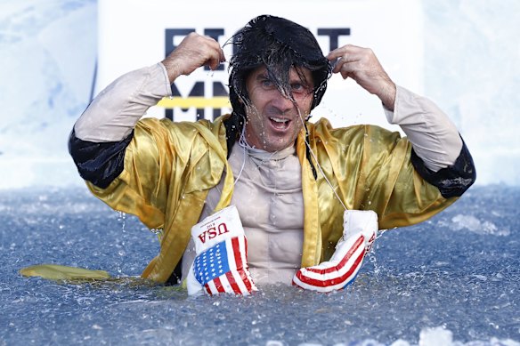 Justin Langer, former Australian cricketer and coach, goes down the slide as Rocky Balboa. 