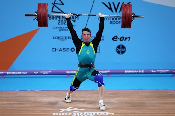 Kyle Bruce of Team Australia performs a clean and jerk during Men's 81kg Final.