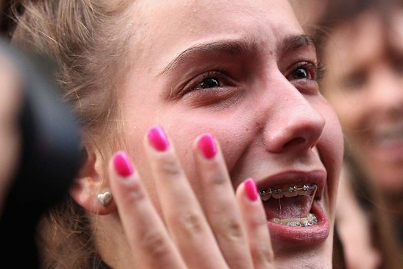 One fan is overcome during One Direction's visit to Sunrise Martin Place studio.