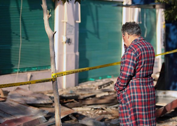 A man looks at rubble in Valparaiso, Chile, after a huge 8.8-magnitude earthquake rocked the country early morning killing at least 147 people.