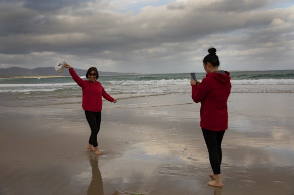 Tourists posing for photos at Bastion Point Beach. 