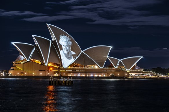 An image of Queen Elizabeth II is projected onto the sails on the day of her death in 2022. 