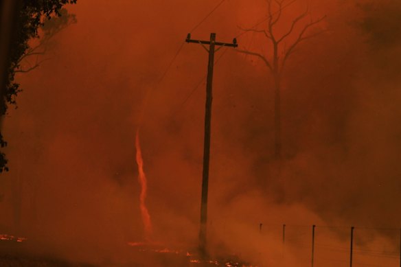 Bushfires rip through Werombi. RFS crew from out of area (Otford) race through flames to get to homes under threat. Fire whirls on Braddock rd Werombi

