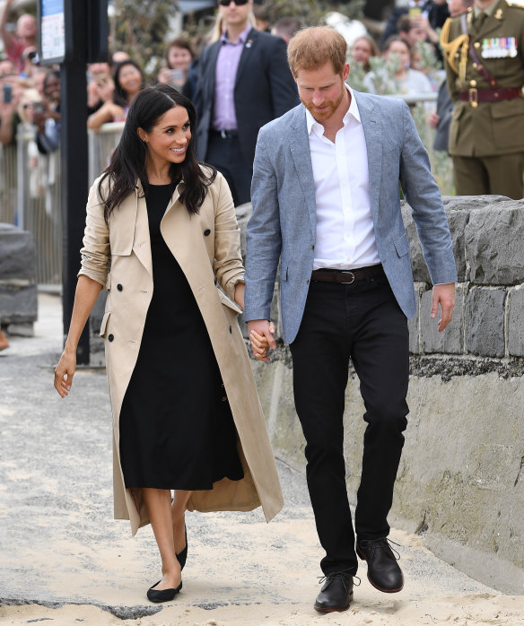 Outfit change: Meghan dons a black dress ... very fitting for Melbourne.