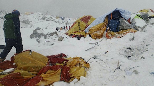 A man approaches the scene after an avalanche triggered by a massive earthquake swept across Everest Base Camp, Nepal.