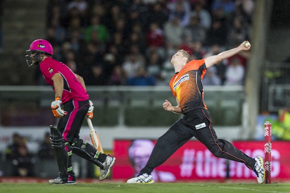Jason Behrendorff of the Perth Scorchers whips on in with fellow ACT player Ryan Carters of the Sydney Sixers batting.