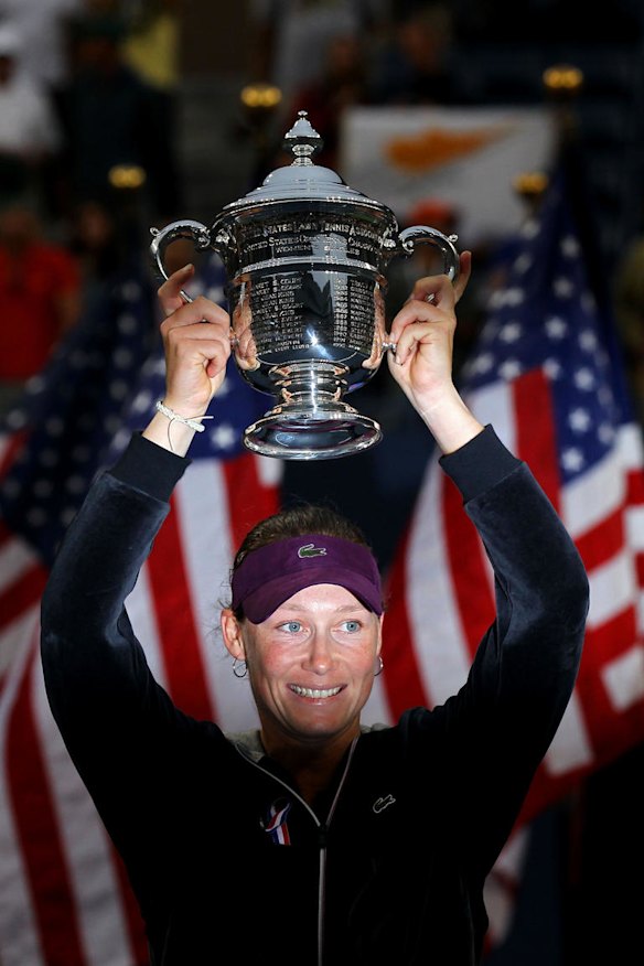 Samantha Stosur of Australia celebrates with the US Open championship trophy after defeating Serena Williams.
