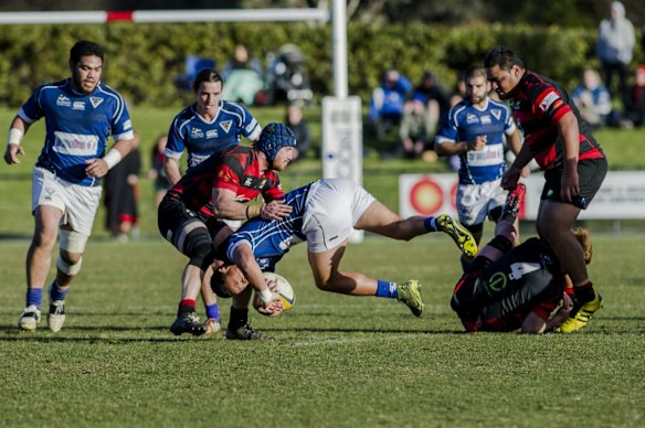 Royals Lausii Taliauli is brought down by Gungahlin's Xavier Duffy.