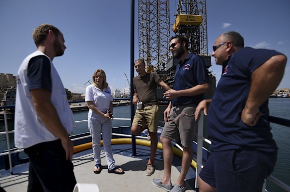 Medecins Sans Frontieres (MSF) emergency co-ordinator Will Turner (left), Migrant Offshore Aid Station (MOAS) founders Regina Catrambone (2nd from left) and Christopher Catrambone (2nd from right) with Mark Micallef from Migrant Report (3rd from left) and Marco Cauchi (right) MOAS search and rescue operations team leader? on the upper deck of the MY Phoenix, a rescue boat operated by MOAS with the support of Medecins Sans Frontieres as it prepares to sail to the search and rescue zone.