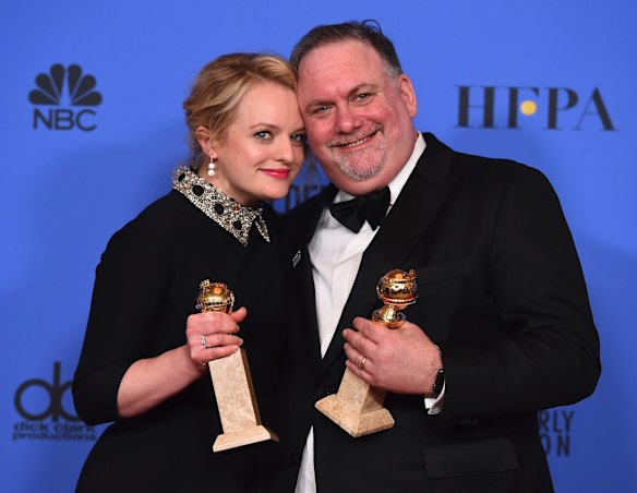 Elisabeth Moss and Bruce Miller with their awards for <i>The Handmaid's Tale</i>.