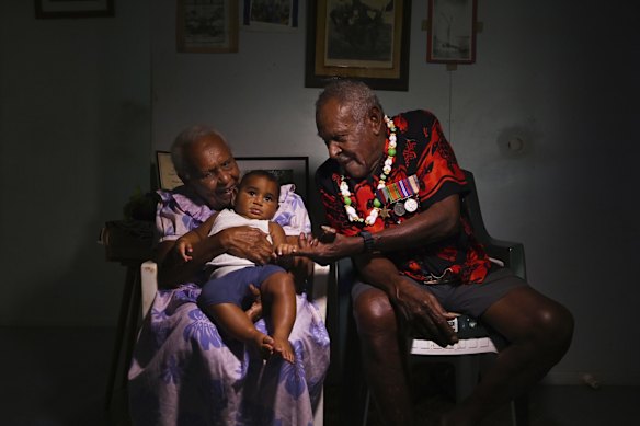 Mebai Warusam, 97, wearing his WWII medals, is pictured (right) with his wife Rona Warusam, 93, and great-grandchild Masterson Waia, 5 months old at their home on Saibai Island. Mebai is the last surviving member of the Torres Strait Light Infantry Battalion (TSLIB) which was made up of 880 Islanders and was Australia's first and only all-Indigenous unit. 


