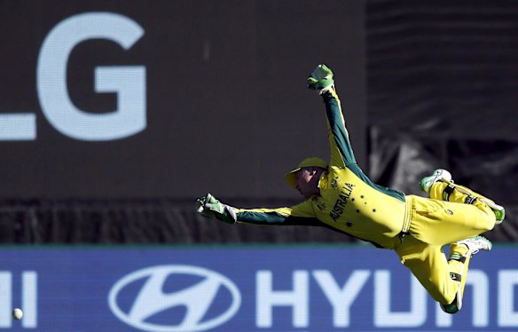 Australia's wicketkeeper Brad Haddin dives but fails to stop a boundary hit by New Zealand's Grant Elliott during their Cricket World Cup final match at the Melbourne Cricket Ground (MCG) March 29, 2015.    