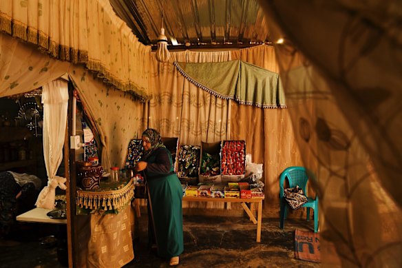 Samiha al-Kelani from Ghouta restocks her small shop the family has in their front room of her home in Zaatari Camp in Jordan. Samiha is also a sewing trainer at a local ngo in the camp teaching women new skills. Samiha and her family fled Syria in January, 2014.