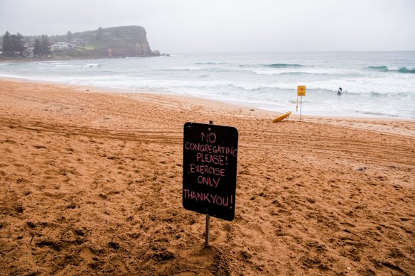 A sign on Avalon Beach on sunday morning asking the public not to congregate.