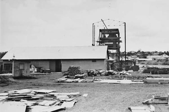 Construction material litters the foreground of the New Farm powerhouse, circa 1926.