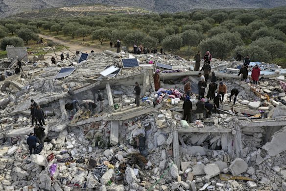 Civil defence workers and residents search collapsed buildings in Harem near the Turkish border, Idlib province, Syria.