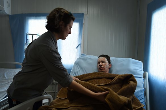 Australian nurse Taryn Anderson tends to Abdulrahman Abdulaaly.