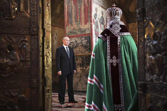 Russian President Vladimir Putin attends a service held by Russian Orthodox Patriarch Krill, right, after the inauguration ceremony in the Kremlin in Moscow.