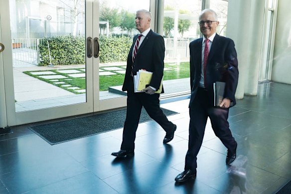 Deputy Prime Minister Michael McCormack and Prime Minister Malcolm Turnbull depart the partyroom meeting after a leadership spill, at Parliament House in Canberra.