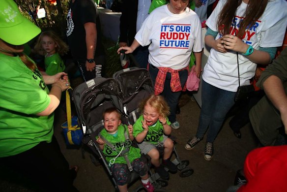 Toddlers in a stroller scream after a woman fell on them as Prime Minister Kevin Rudd exited a campaign rally in Westmead, Sydney.