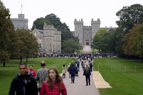 Mourners on the Long Walk gather to pay their respects at Windsor Castle, Berkshire, following the death of Queen Elizabeth II, Friday Sept 9, 2022.