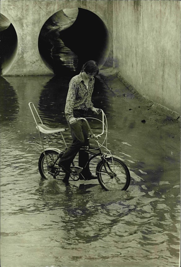 With nothing else to do on a wet Sunday afternoon in Sydney, Omar Thompson, 14, of Enfield, decided to ride his bicycle through the Cooks River Canal under the Hume Highway at Enfield. December 30, 1973. 