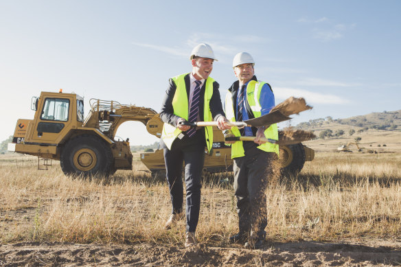 Village Building Co. chief executive Travis Doherty and Queanbeyan-Palerang Regional Council mayor Tim Overall turn the first sod at the $1 billion South Jerrabomberra estate on Wednesday morning.