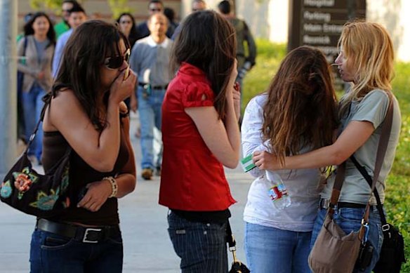 Fans weep and console each other outside outside the UCLA Medical Center following the death of music legend Michael Jackson.