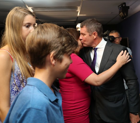 Premier Mike Baird embraces his family after a press conference announcing his resignation in Sydney. 