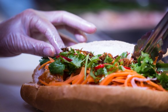 Step 4: Add the remaining banh mi fillers including pickled carrot and radish, fresh coriander, cucumber slices, and fresh chilli to taste. Finish with a squirt of soy sauce to highlight the salty-sweet flavours of xiu mai.