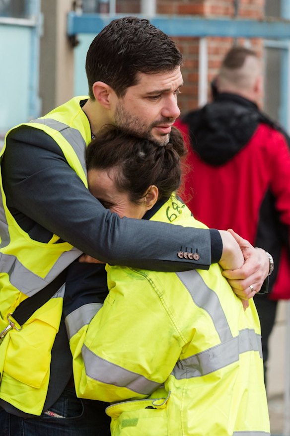 People react outside Brussels airport after explosions rocked the facility in Brussels, Belgium.