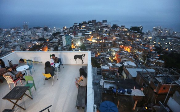 Guests gather on the terrace of the Tiki Hostel in the Cantagalo favela.