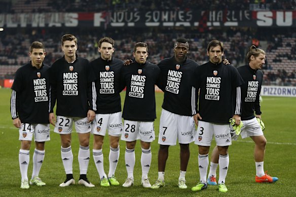 Lorient players wear tee shirt in tribute to the victims of the attack by armed gunmen on the offices of French satirical newspaper Charlie Hebdo in Paris, prior to the French L1 football match Nice (OGC Nice) vs Lorient (FCL) on Januay 10, 2015 at the "Allianz Riviera" stadium in Nice, southeastern France.