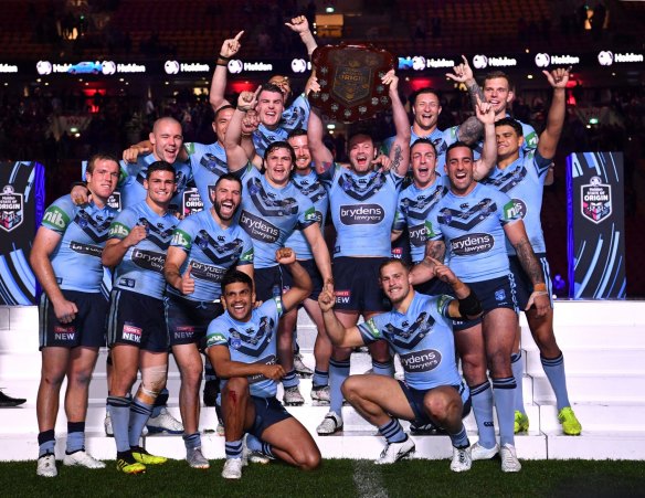 'We need to be better': NSW players hold up the shield after winning the 2018 Origin series.