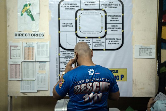 A man talks on a mobile phone at a makeshift disaster relief operations centre ahead of Typhoon Mangkhut's arrival in Tuguegarao.
