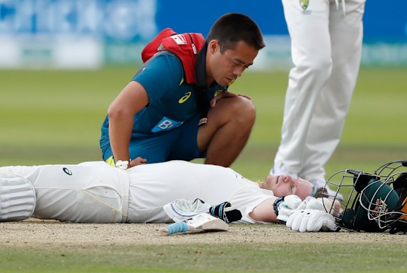 Steve Smith receives medical assistance after being hit in the neck by Jofra Archer. He left the field but returned to bat once Peter Siddle was dismissed. 