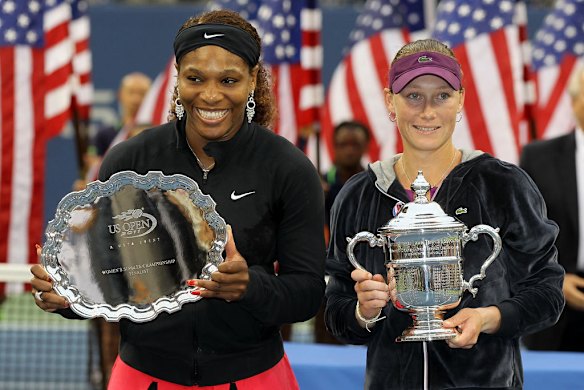 Samantha Stosur of Australia (right) celebrates with the championship trophy alongside Serena Williams of the United States (left) after the US Open women's singles final.