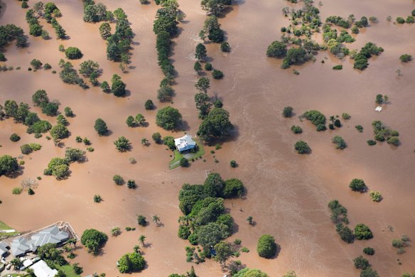 A lone house shown in an aerial photo taken on Friday in the Logan region where residents in low lying areas remained on flood alert on Saturday afternoon.