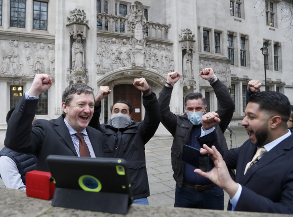 Uber drivers and their union celebrate after hearing the verdict outside the Supreme Court.