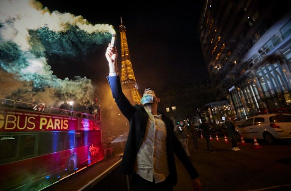 Parisians ring in the New Year 2021 near the Eiffel Tower in Paris, France. 