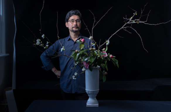 Shoso Shimbo with one of his ikebana arrangements made from camellias and flowering quince from his garden