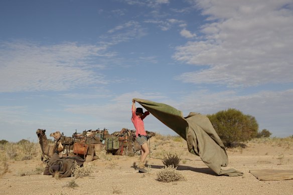 Sophie Matterson makes camp with her camels after a day walking near Oodnadatta, Australia.  Sophie's day starts at 5:30am with a fire and breakfast made while the camels graze for an hour. 