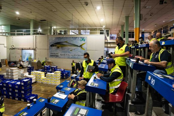 Buyers prepare to bid for fresh seafood at the Sydney Fish Market.