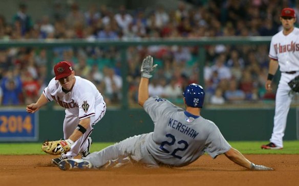 Arizona 2nd baseman Aaron Hill tags Clayton Kershaw to get the out in the Opening Game of the 2014 MLB Season Between the Arizona Diamonbacks and LA Dodgers at the SCG.