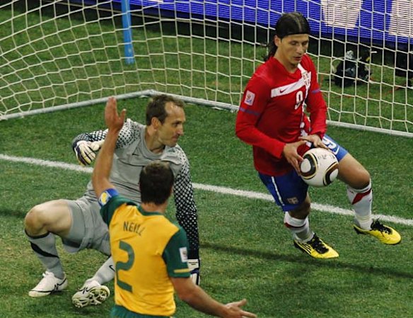 Australia goalkeeper Mark Schwarzer, left, gets up as Serbia's Marko Pantelic, right, picks up the ball after scoring a goal.
