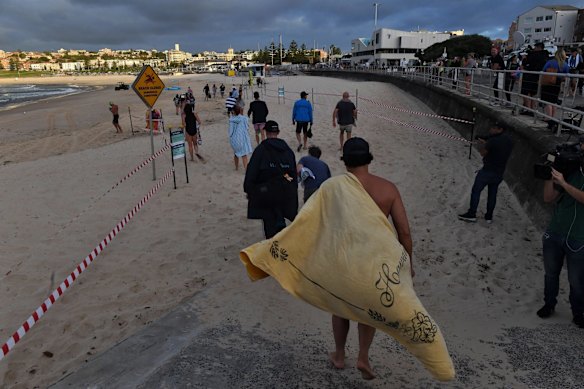 Swimmers return to Bondi beach in designated areas and times.

