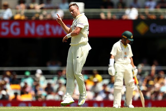 Ollie Robinson of England celebrates taking the wicket of Alex Carey of Australia.