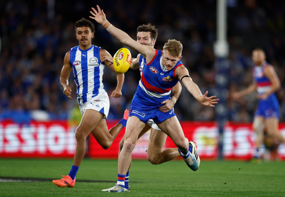 Battle: Adam Treloar and Luke McDonald in action at Marvel Stadium.