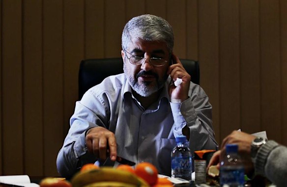 Khalid Mishal talks on a mobile phone during a meeting at a house in Doha, Qatar.