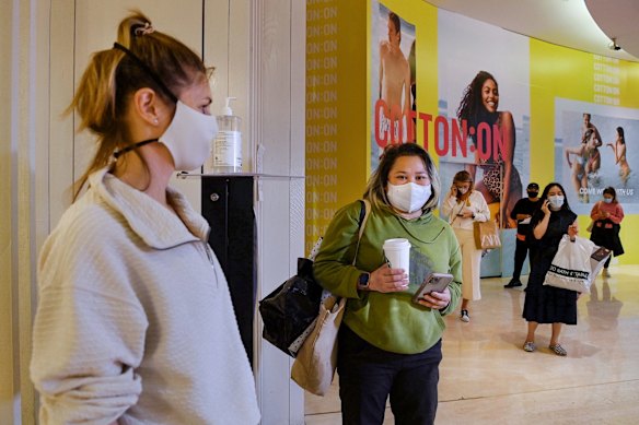Racqel Garwood, 2nd from left, queues to enter Lulu Lemon store in Westfield Bondi Junction shopping centre on the first day of relaxed COVID-19 restrictions for fully vaccinated people.